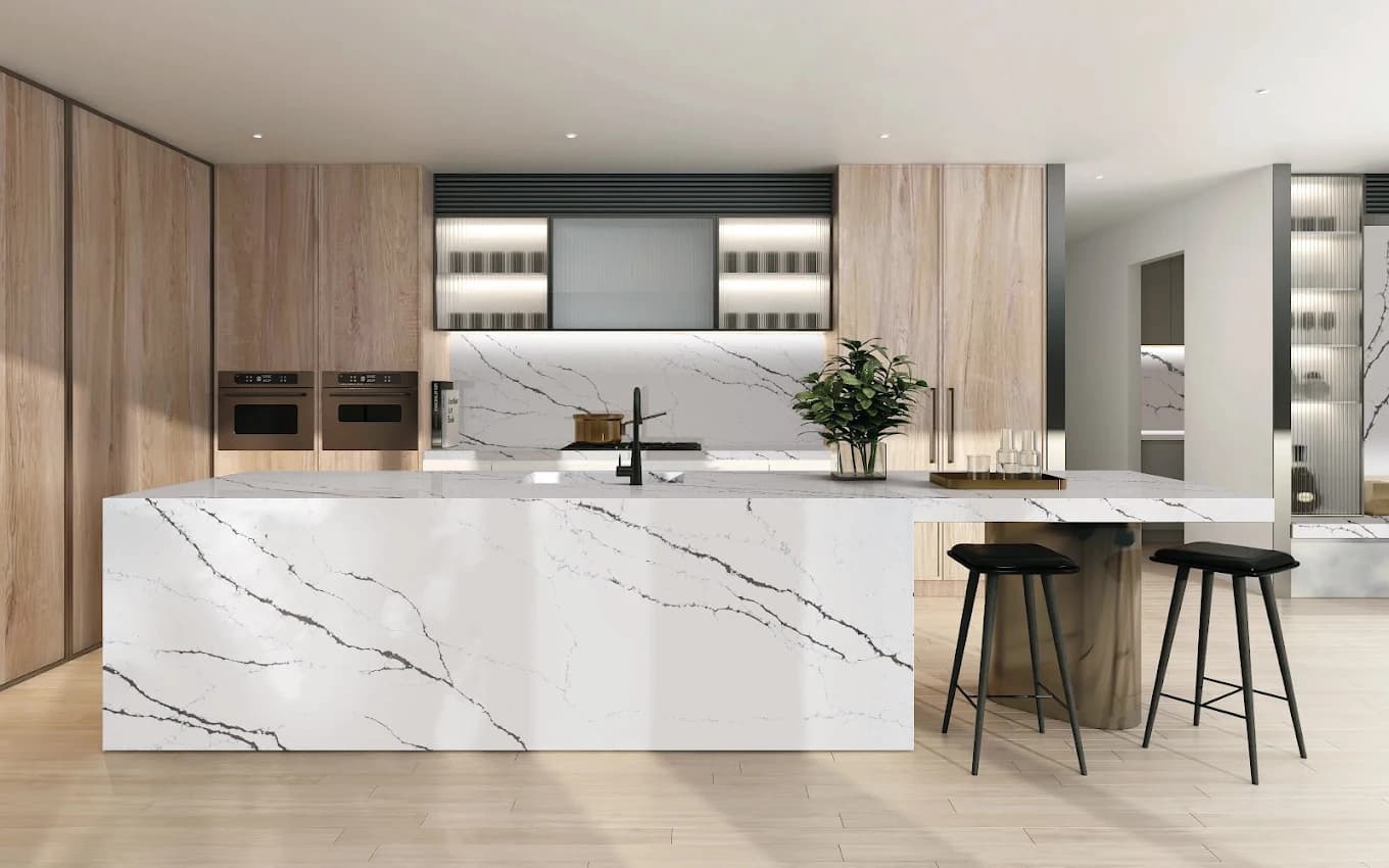 Light-wood kitchen cabinetry with a calacatta quartz waterfall island — showroom design from H&E's Houston collection